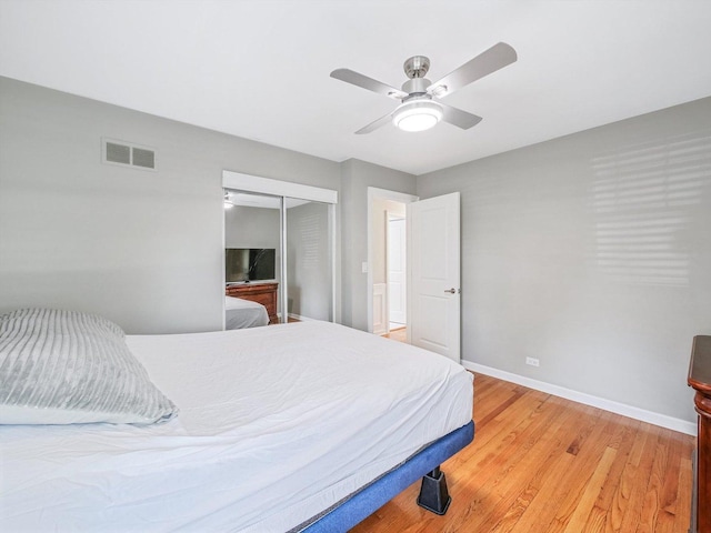 bedroom with a ceiling fan, a closet, baseboards, visible vents, and light wood-style floors