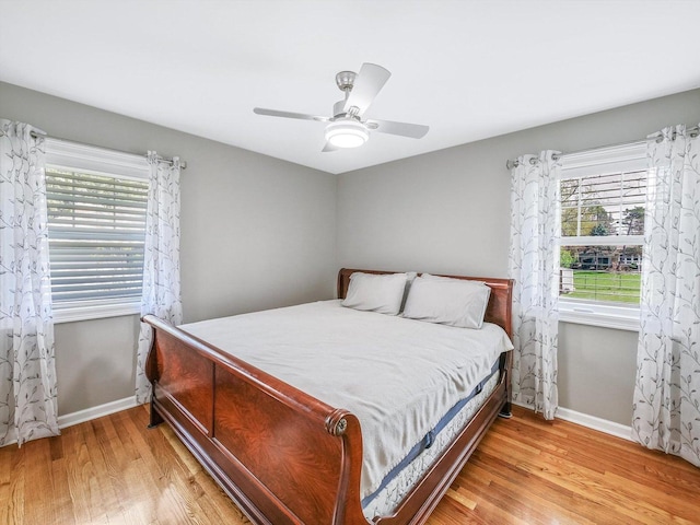bedroom featuring baseboards, ceiling fan, and wood finished floors