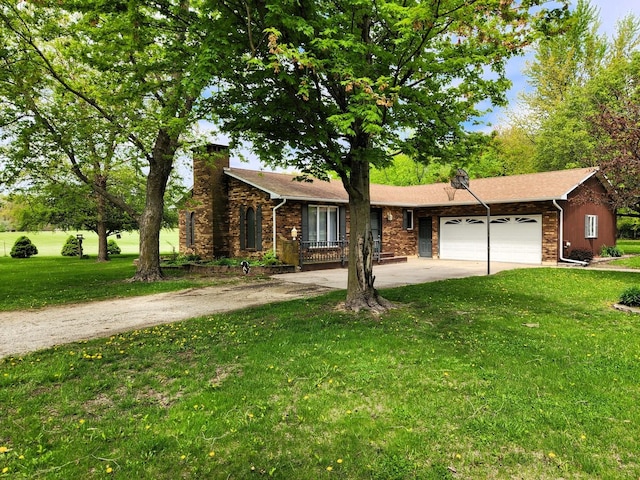 view of front facade featuring driveway, a garage, a front yard, a chimney, and stone siding