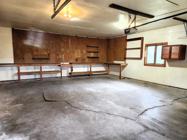garage with a garage door opener and a workshop area