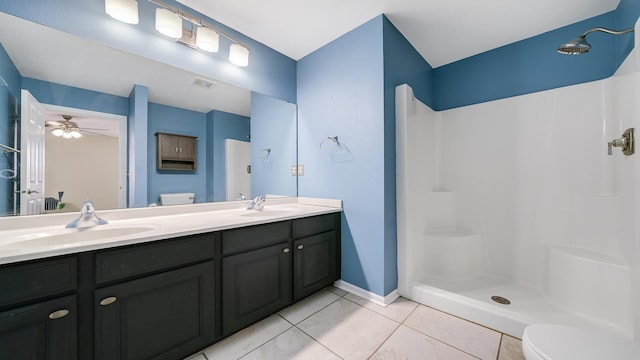 full bath featuring a sink, toilet, tile patterned floors, and walk in shower