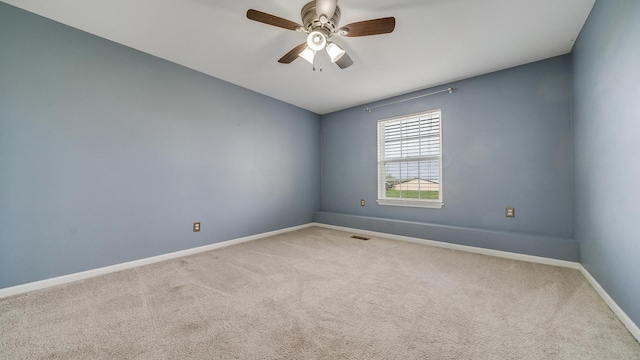carpeted empty room with baseboards and ceiling fan