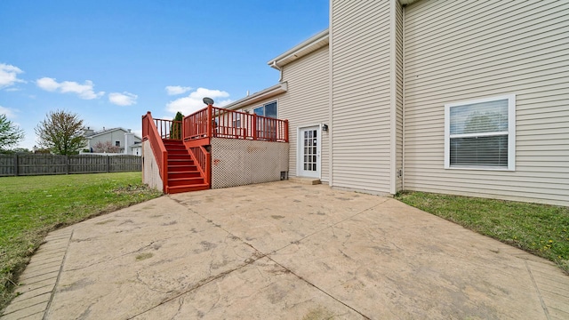 exterior space featuring a deck, stairway, and fence