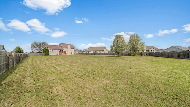 view of yard with a residential view and a fenced backyard