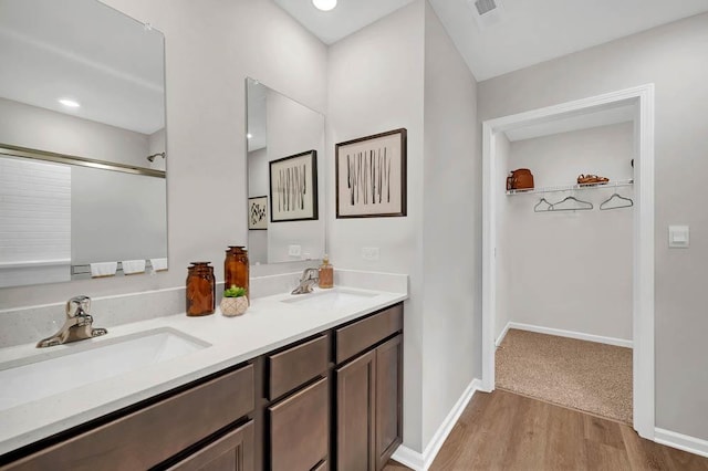 4202 High Point Ct, Joliet, IL 60436 - full bathroom with a sink, a spacious closet, visible vents, and wood finished floors