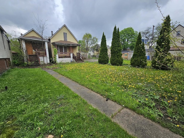 11920 S Calumet Ave, Chicago, IL 60628 - view of yard featuring stairs and covered porch
