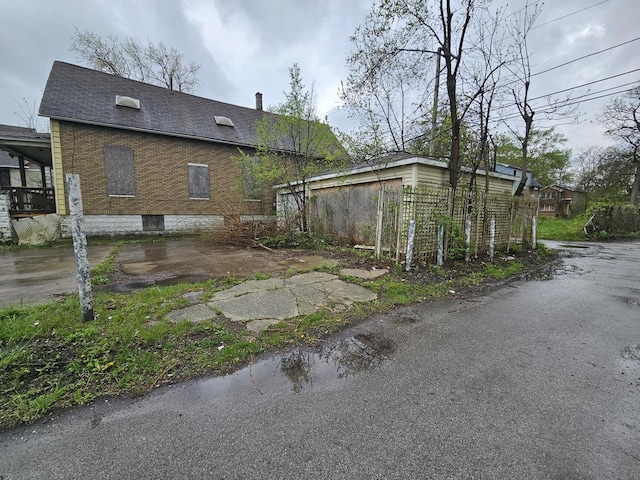 11920 S Calumet Ave, Chicago, IL 60628 - view of property exterior with a shingled roof and brick siding