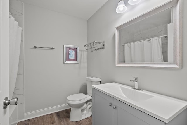 5177 Coventry Ln Unit D, Gurnee, IL 60031 - bathroom featuring toilet, wood finished floors, a shower with curtain, baseboards, and vanity