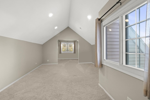 additional living space with baseboards, recessed lighting, carpet, and vaulted ceiling