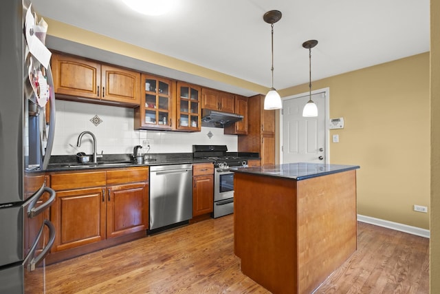 kitchen with brown cabinets, stainless steel appliances, and a sink