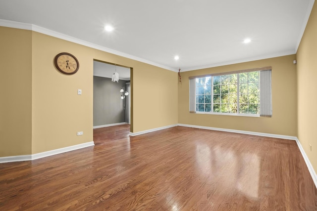 spare room with baseboards, ornamental molding, recessed lighting, and wood finished floors