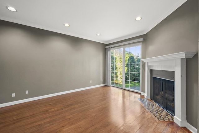 unfurnished living room featuring baseboards, a fireplace with flush hearth, recessed lighting, and wood finished floors