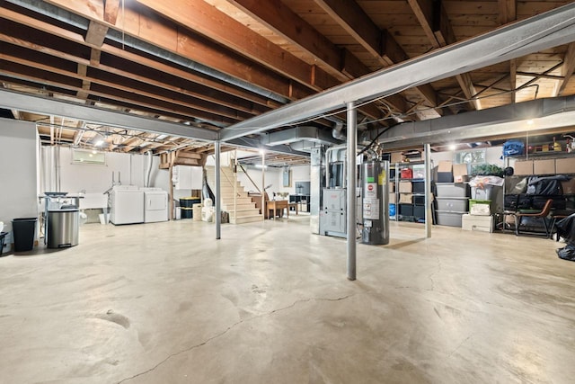 unfinished below grade area featuring gas water heater, separate washer and dryer, and stairway