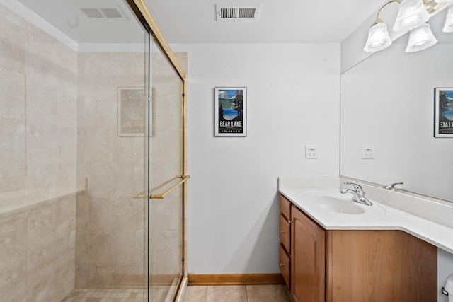 full bath with a shower stall, tile patterned floors, and vanity