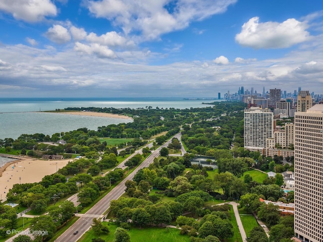 birds eye view of property with a water view and a view of city