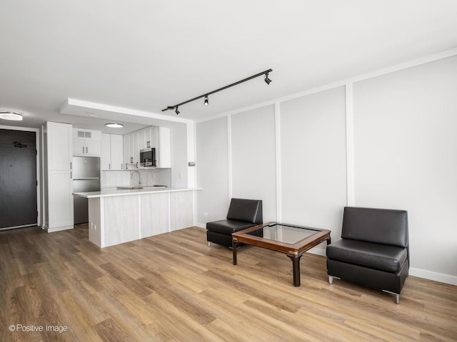 sitting room featuring rail lighting, visible vents, and wood finished floors