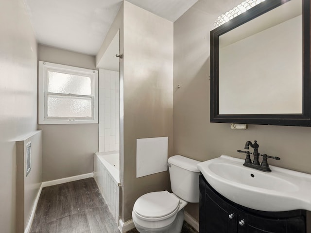 full bathroom featuring vanity, toilet, wood finished floors, and baseboards
