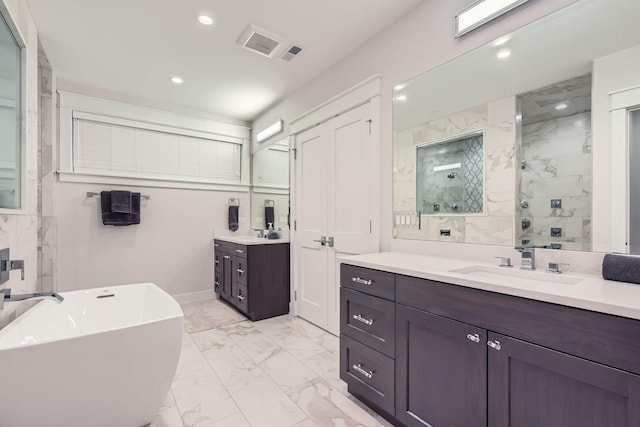 1955 N Halsted St Unit 1, Chicago, IL 60614 - full bath featuring marble finish flooring, two vanities, a marble finish shower, a freestanding bath, and recessed lighting