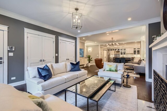 1955 N Halsted St Unit 1, Chicago, IL 60614 - living room featuring a chandelier, crown molding, baseboards, recessed lighting, and wood finished floors