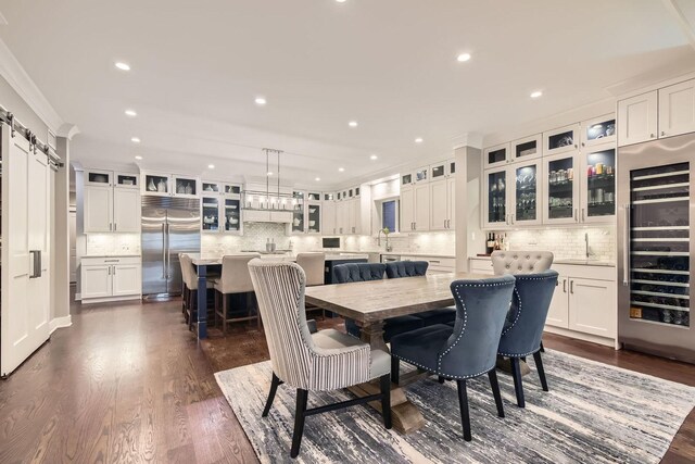 1955 N Halsted St Unit 1, Chicago, IL 60614 - dining area featuring wine cooler, dark wood-style flooring, crown molding, recessed lighting, and bar area