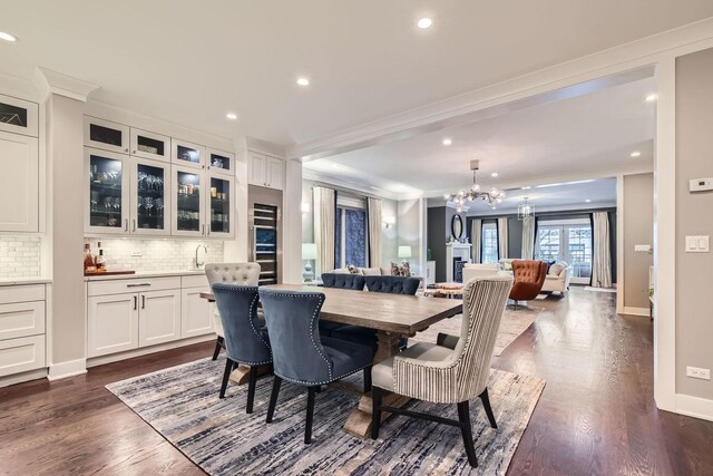 1955 N Halsted St Unit 1, Chicago, IL 60614 - dining area featuring a chandelier, ornamental molding, dark wood-style flooring, recessed lighting, and baseboards