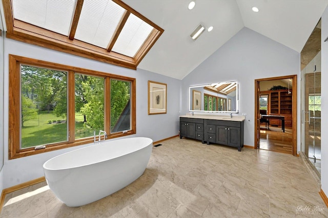 11 N Meadow Ct, South Barrington, IL 60010 - bathroom featuring healthy amount of natural light, baseboards, high vaulted ceiling, a freestanding bath, and vanity