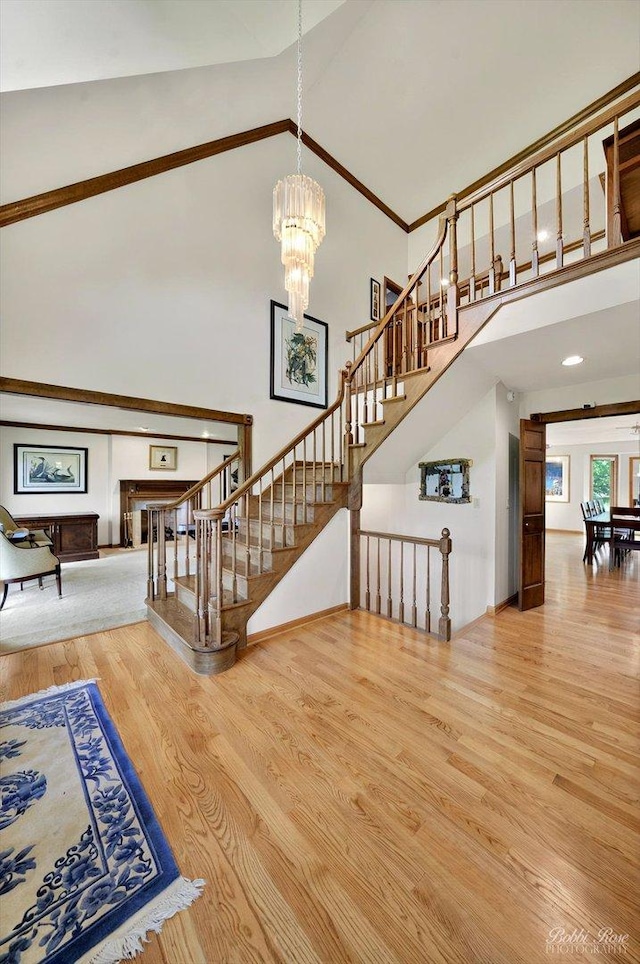 11 N Meadow Ct, South Barrington, IL 60010 - stairway featuring wood finished floors, high vaulted ceiling, and a chandelier