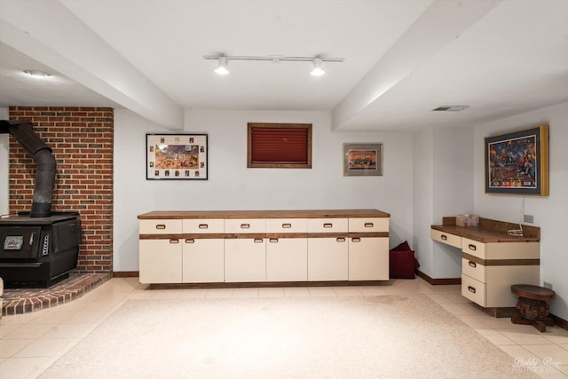 11 N Meadow Ct, South Barrington, IL 60010 - bathroom with tile patterned flooring, track lighting, a wood stove, and baseboards