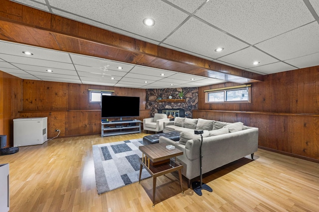 559 Coolidge Ave, Glen Ellyn, IL 60137 - living room featuring wood walls, wood finished floors, a drop ceiling, and a stone fireplace