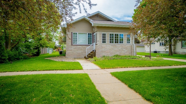 214 W Watson St, Forrest, IL 61741 - view of front of home featuring stone siding, a front yard, and entry steps