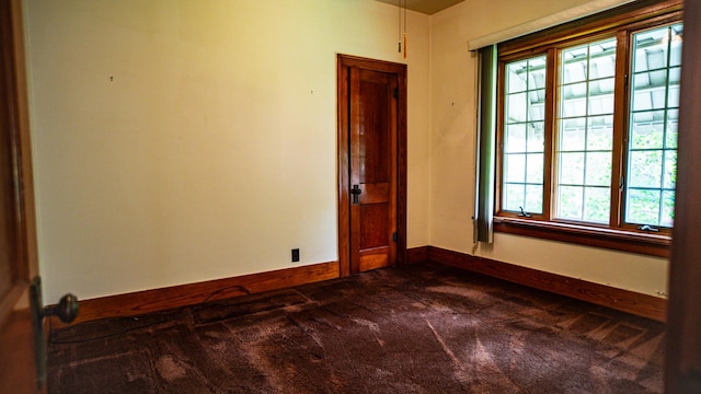 214 W Watson St, Forrest, IL 61741 - empty room with dark colored carpet and baseboards