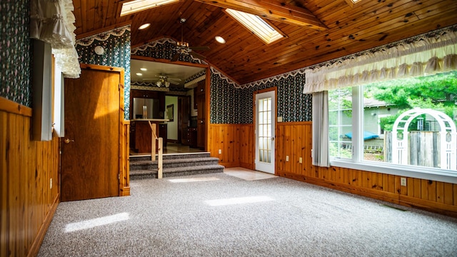 214 W Watson St, Forrest, IL 61741 - unfurnished room featuring wainscoting, a skylight, wallpapered walls, wooden ceiling, and a ceiling fan