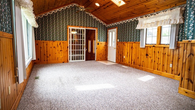 214 W Watson St, Forrest, IL 61741 - spare room featuring a wainscoted wall, vaulted ceiling, carpet floors, a skylight, and wallpapered walls