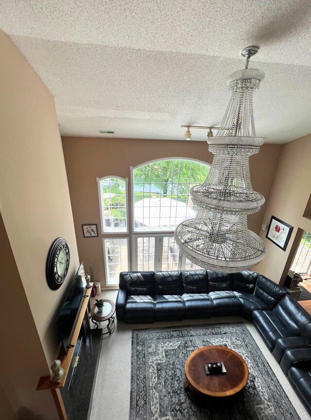 living area featuring carpet flooring, a chandelier, and baseboards