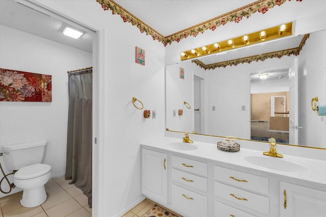 full bathroom featuring tile patterned floors, toilet, double vanity, and a textured ceiling