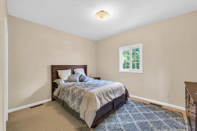 office space with carpet, a textured ceiling, and baseboards