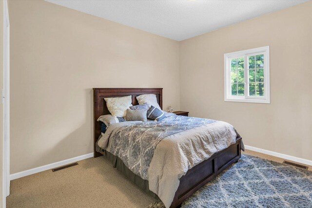 carpeted bedroom featuring baseboards