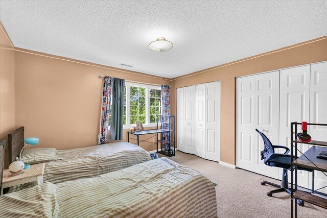 carpeted bedroom featuring baseboards, arched walkways, and a textured ceiling
