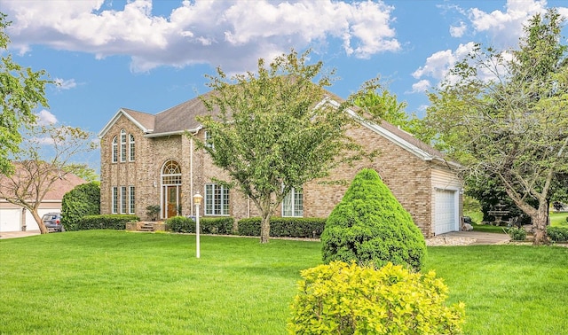 view of front facade with brick siding, a front lawn, and a garage