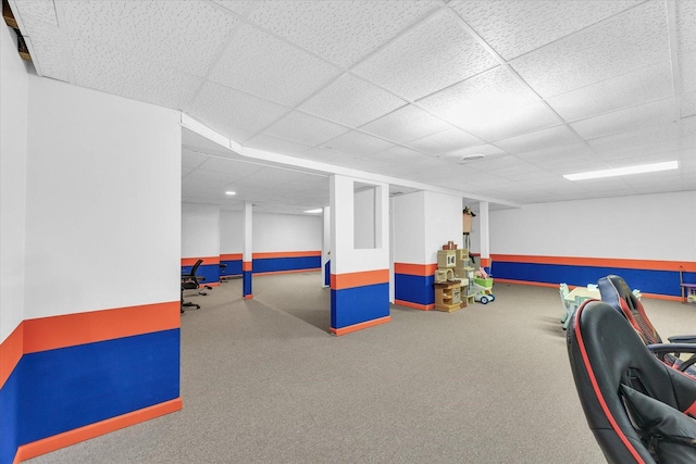 game room with a paneled ceiling and carpet flooring