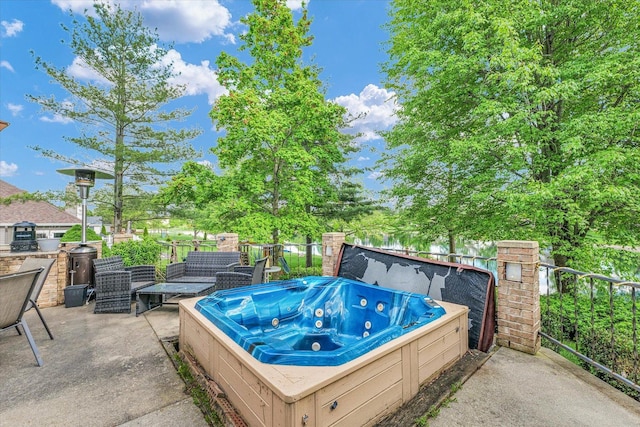 view of patio with an outdoor hot tub