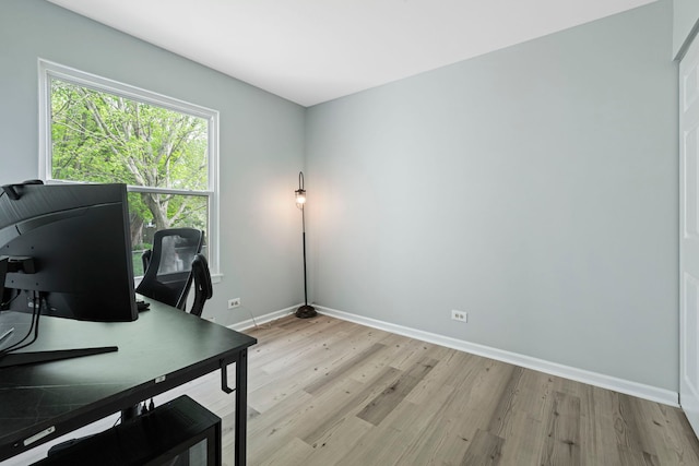 home office with baseboards and light wood finished floors