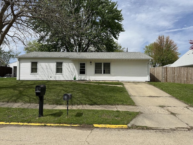 single story home featuring a front lawn and fence