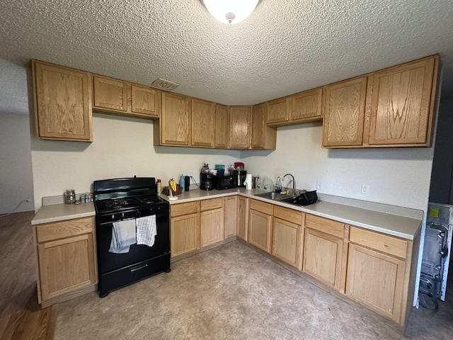 kitchen with a sink, a textured ceiling, visible vents, black range with gas cooktop, and light countertops