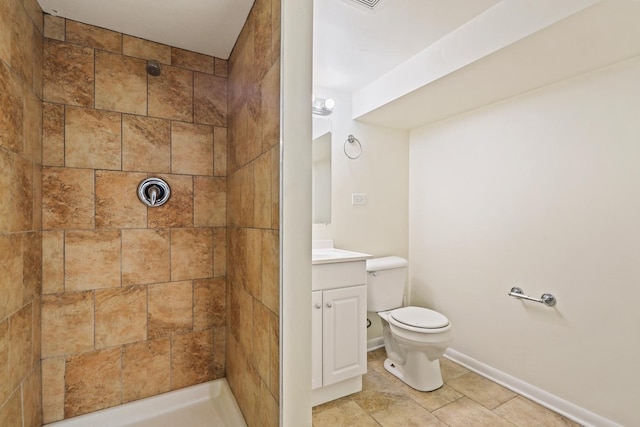 3668 Adams St, Lansing, IL 60438 - bathroom with toilet, a tile shower, vanity, baseboards, and tile patterned floors