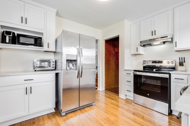 3668 Adams St, Lansing, IL 60438 - kitchen featuring appliances with stainless steel finishes, under cabinet range hood, light countertops, light wood finished floors, and white cabinets