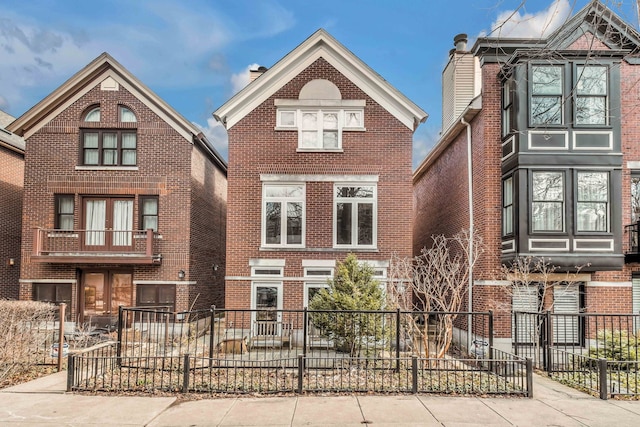 view of front of home with brick siding and fence private yard