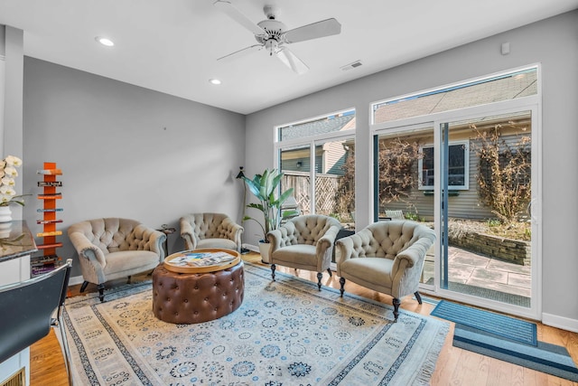 sitting room with wood finished floors, visible vents, recessed lighting, ceiling fan, and baseboards