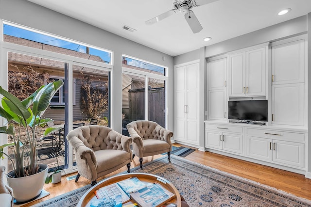 sitting room featuring a ceiling fan, recessed lighting, light wood finished floors, and visible vents