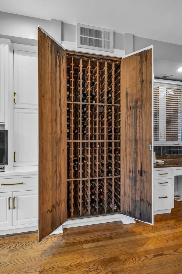 wine area featuring hardwood / wood-style flooring and visible vents